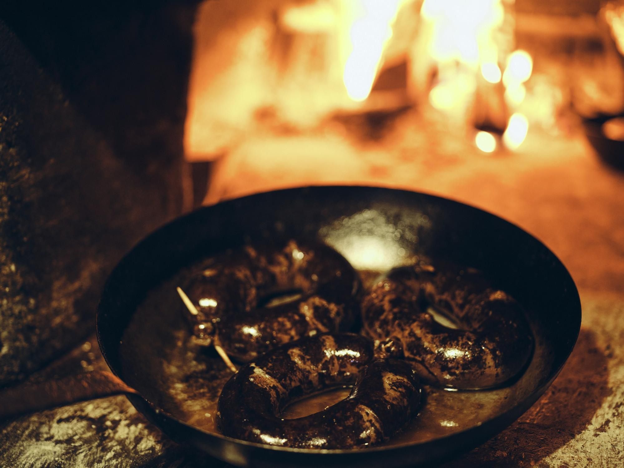 Blood sausages in front of the stove